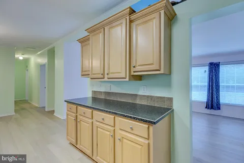 a kitchen with granite countertop a stove and a microwave