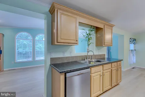 an empty room with fireplace wooden floor and windows