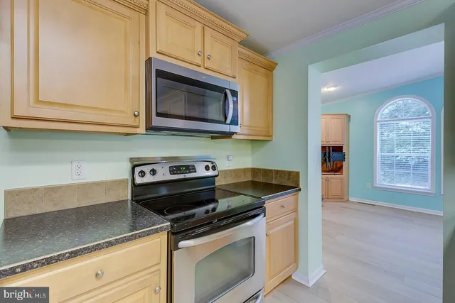 a view of a room with wooden floor and chandelier