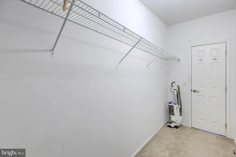 a view of a house with a yard and large trees