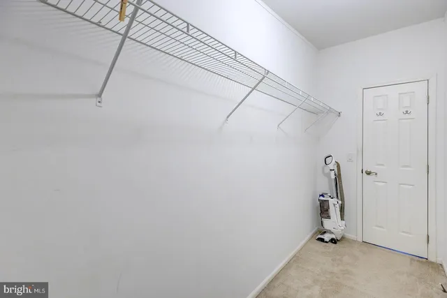 a view of a house with a yard and large trees