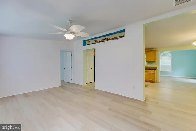 a view of an empty room and wooden floor