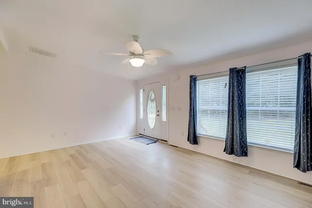 a kitchen with stainless steel appliances granite countertop a sink stove refrigerator and cabinets