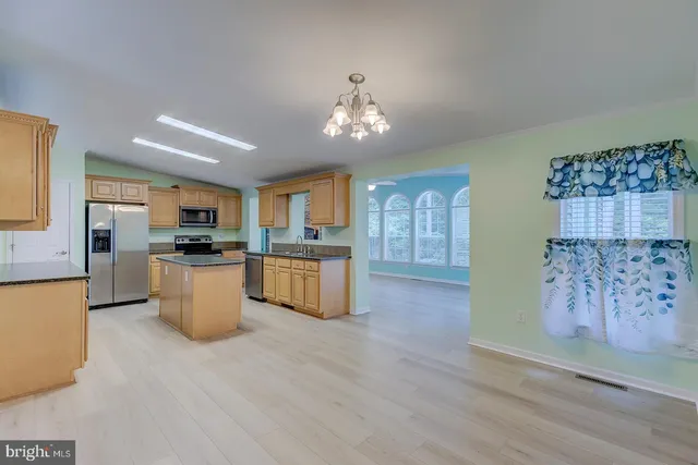 a kitchen with stainless steel appliances granite countertop a sink and cabinets