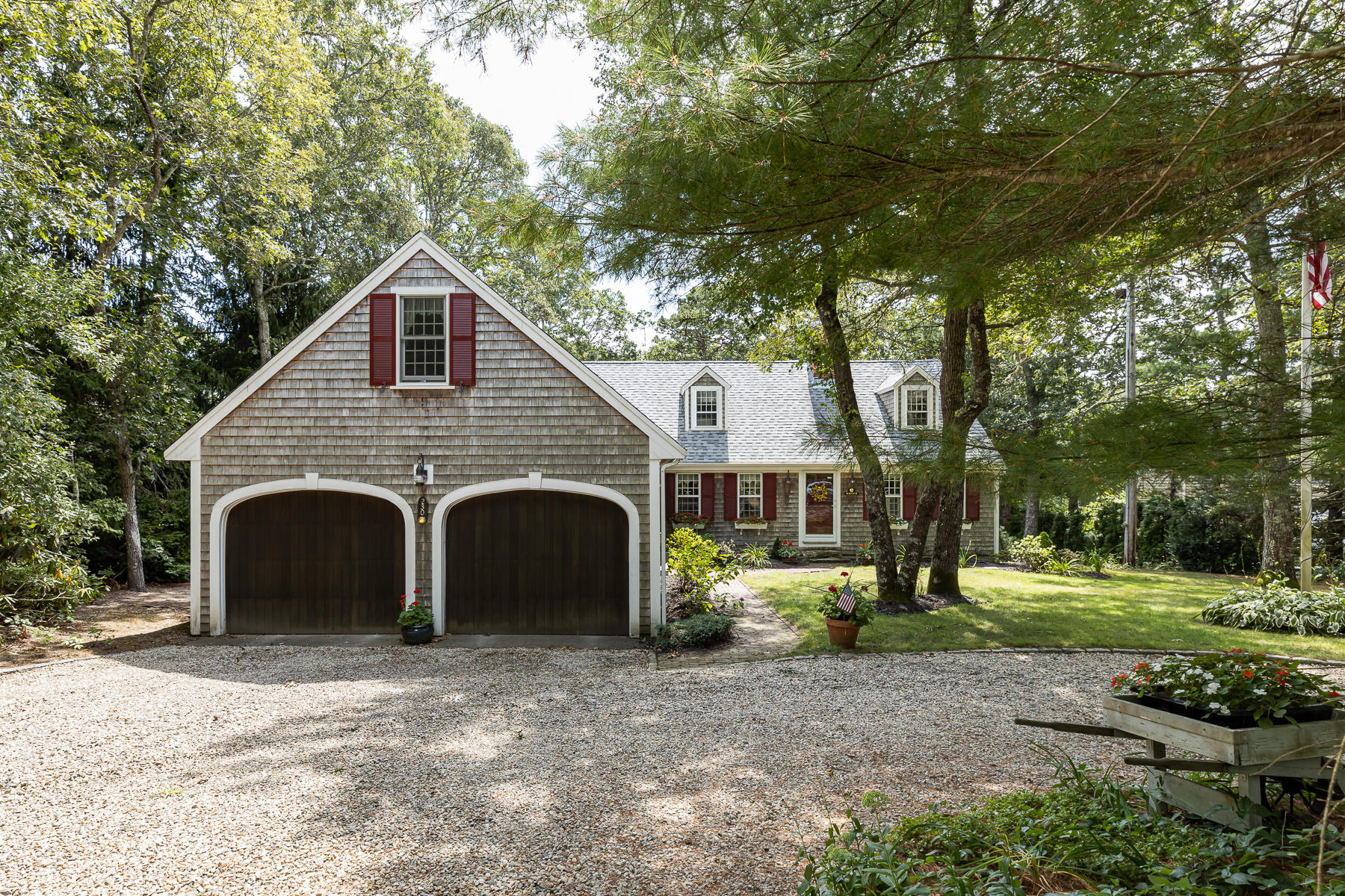 230 Santuit Road Cotuit, MA 02635 - Photo 1 of 46 a view of a white house with a yard and large tree