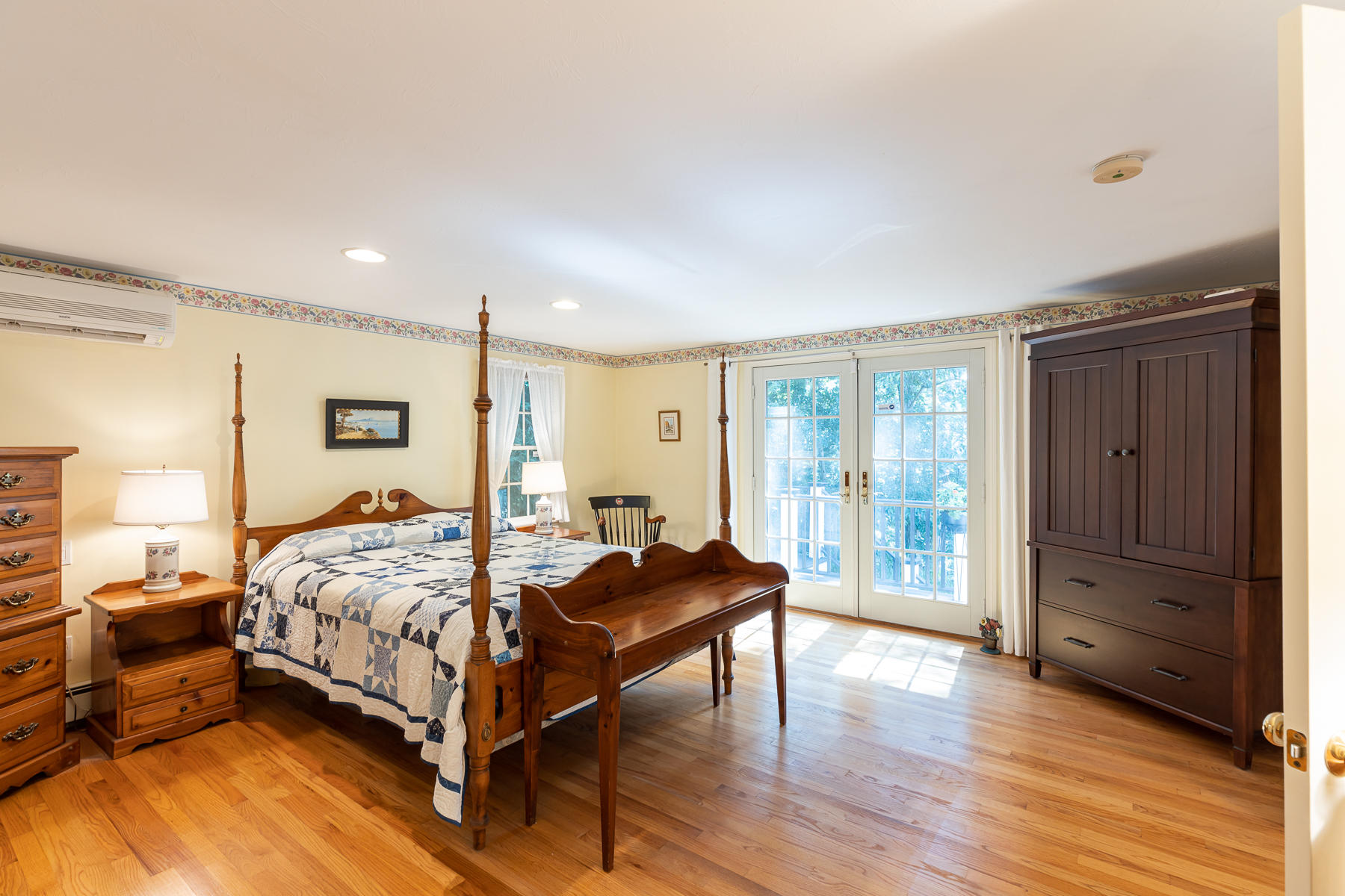 230 Santuit Road Cotuit, MA 02635 - Photo 19 of 46 a bedroom with a bed and wooden floor