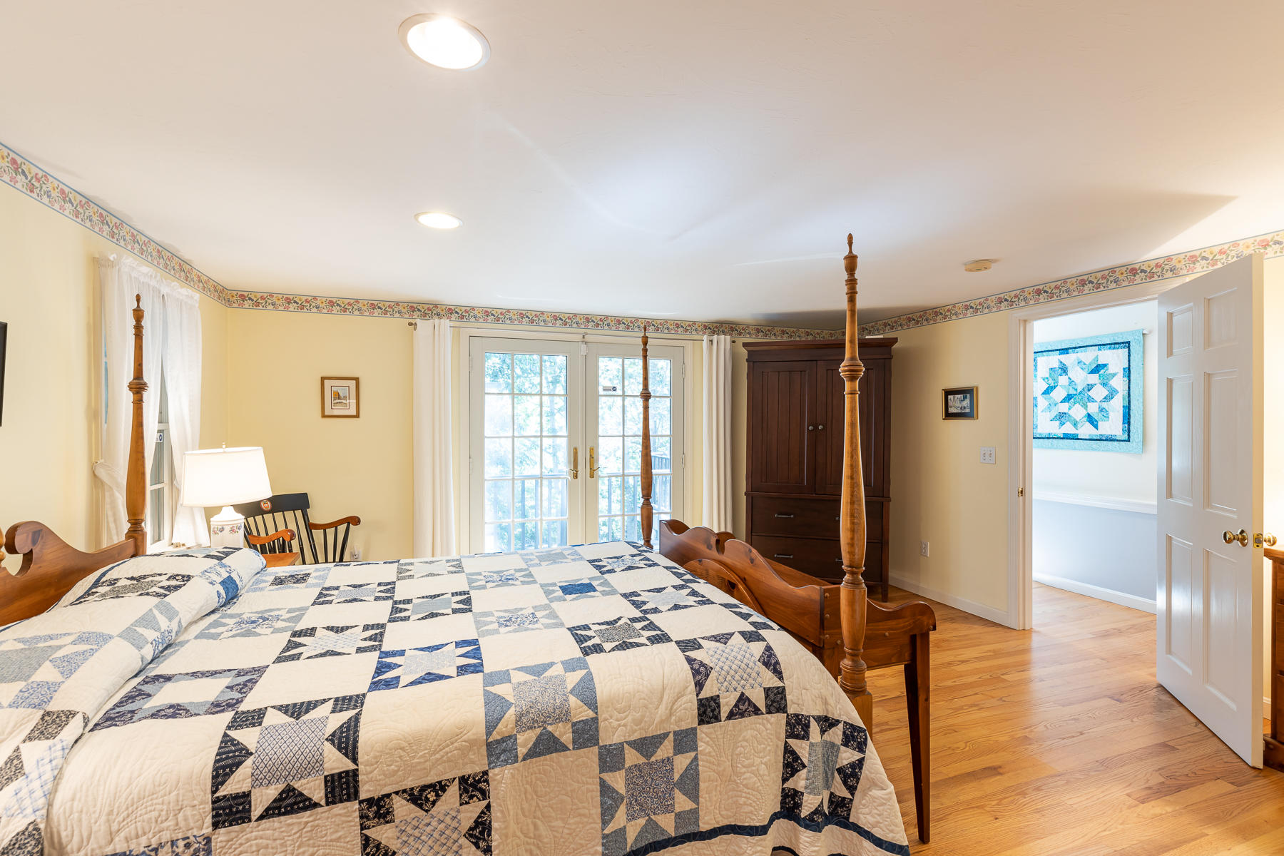 230 Santuit Road Cotuit, MA 02635 - Photo 20 of 46 a spacious bedroom with a bed a dresser and a large mirror