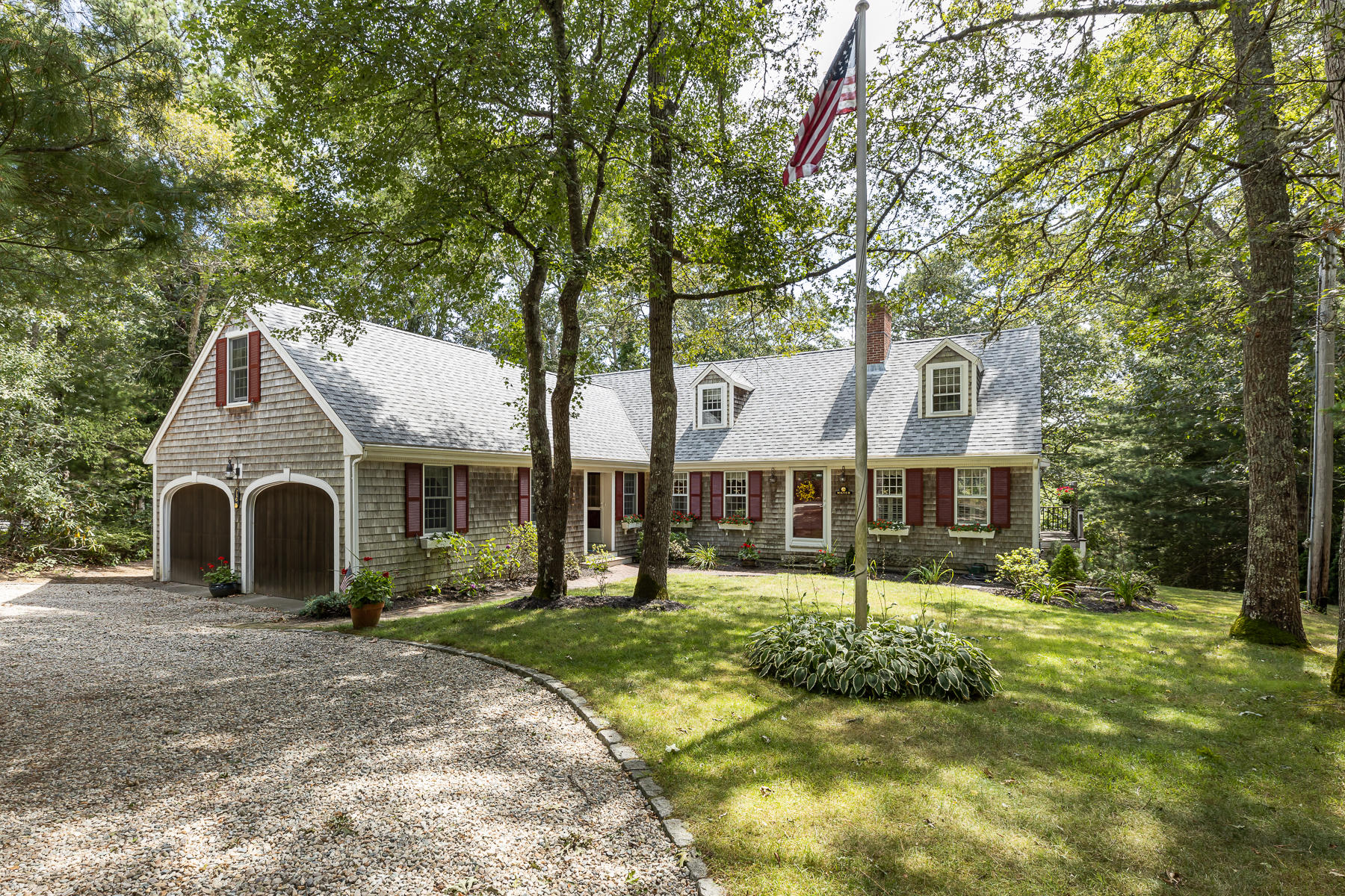 230 Santuit Road Cotuit, MA 02635 - Photo 2 of 46 a front view of a house with a yard