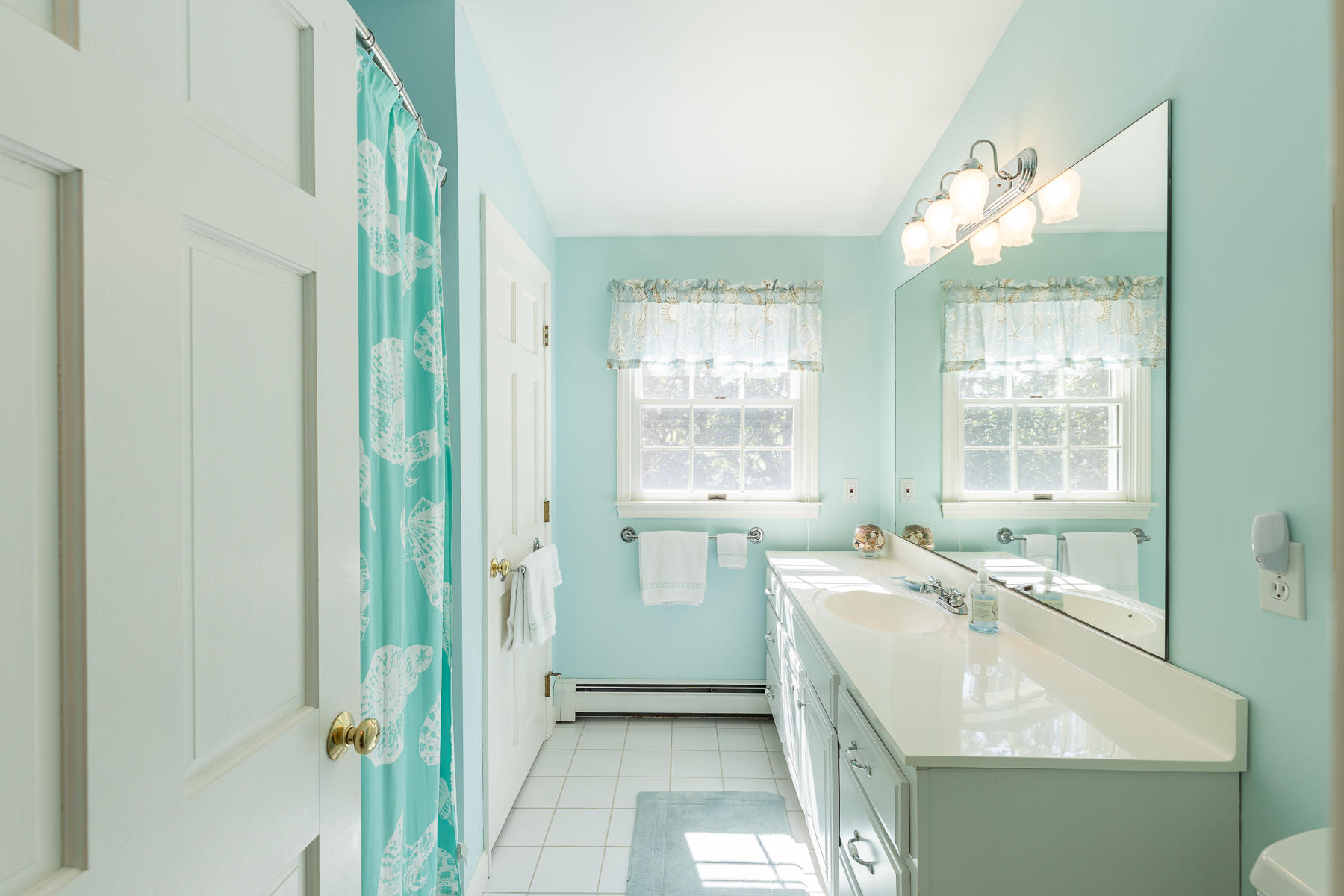 230 Santuit Road Cotuit, MA 02635 - Photo 24 of 46 a bathroom with a granite countertop sink a bathtub and next to a window