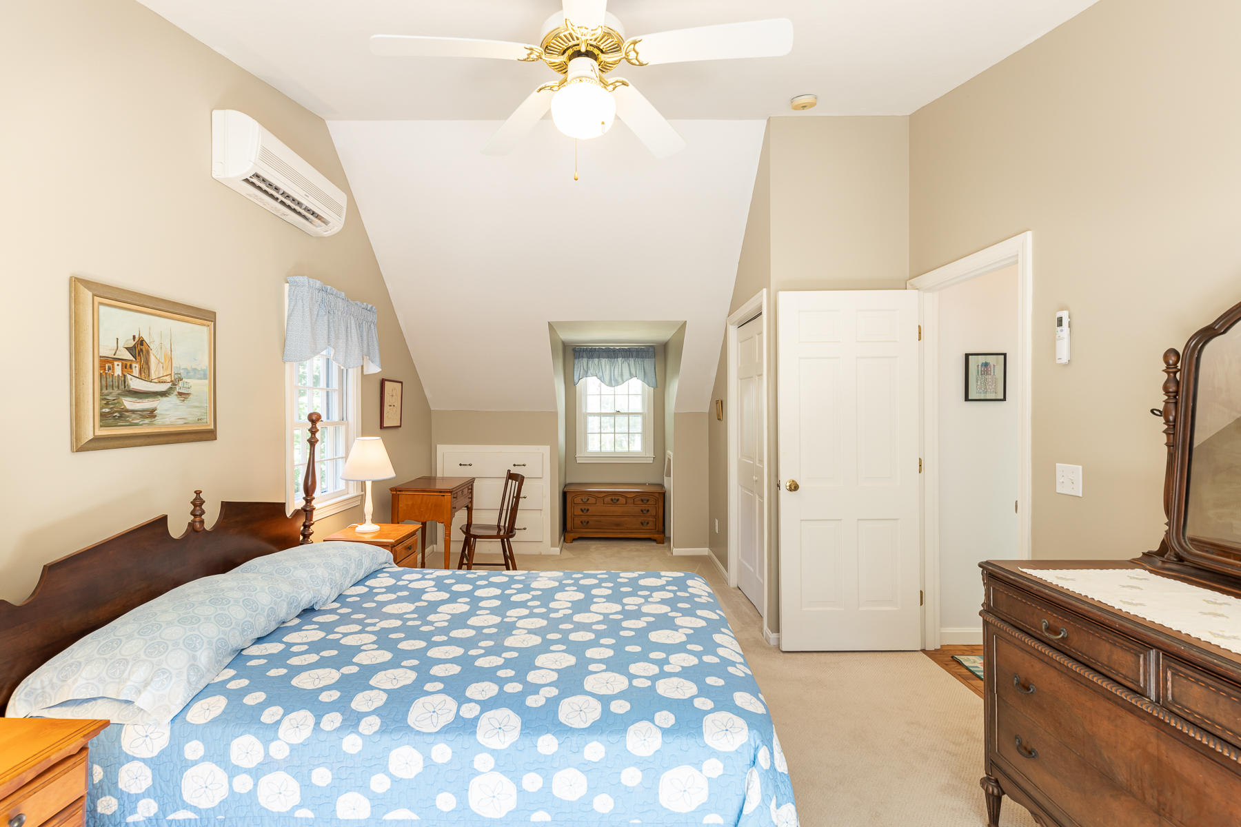 230 Santuit Road Cotuit, MA 02635 - Photo 25 of 46 a bedroom with a large bed and a chandelier