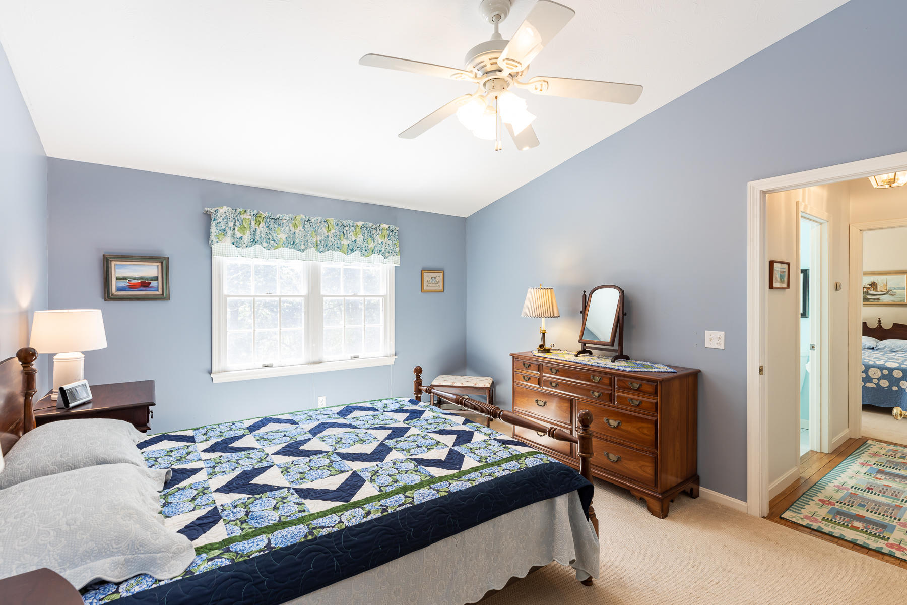 230 Santuit Road Cotuit, MA 02635 - Photo 27 of 46 a bedroom with a bed and a chandelier