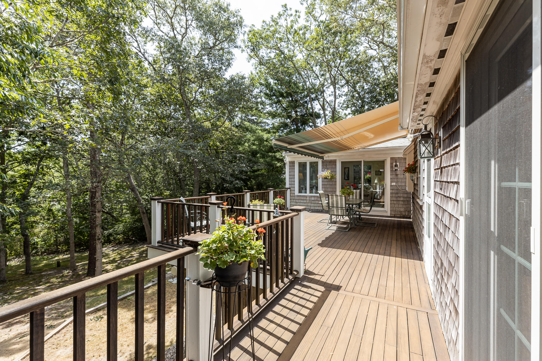 230 Santuit Road Cotuit, MA 02635 - Photo 31 of 46 a balcony with wooden floor table and chairs