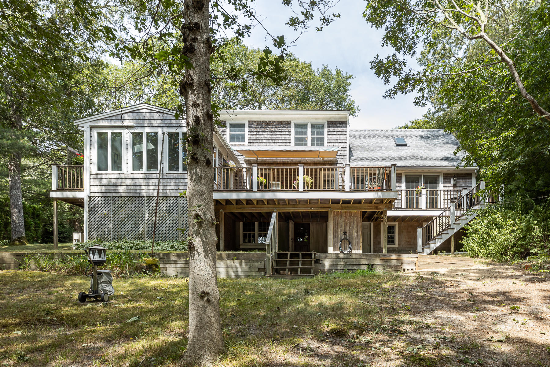 230 Santuit Road Cotuit, MA 02635 - Photo 33 of 46 a front view of a residential apartment building with a yard