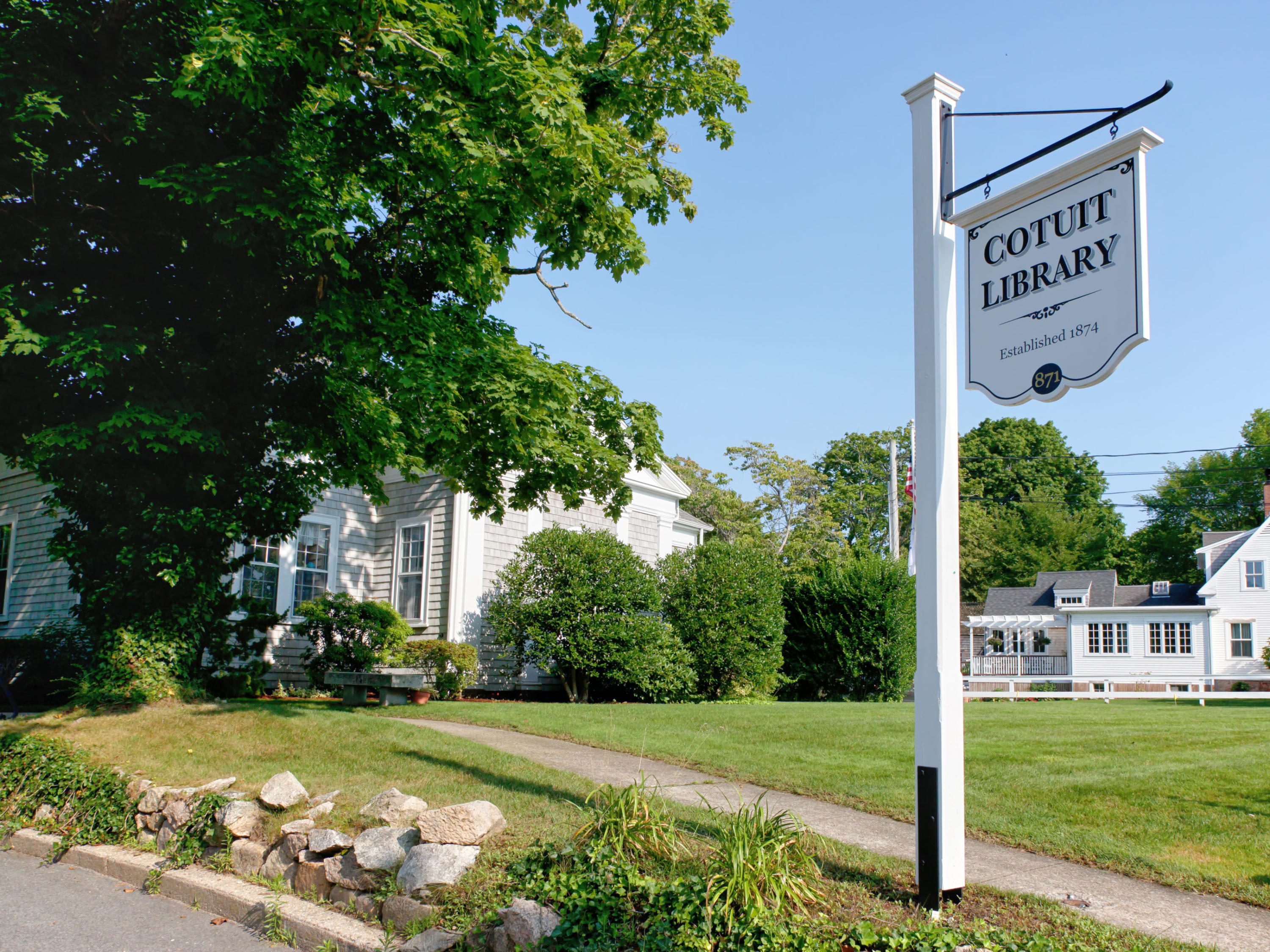 230 Santuit Road Cotuit, MA 02635 - Photo 40 of 46 a view of a street with a sign board