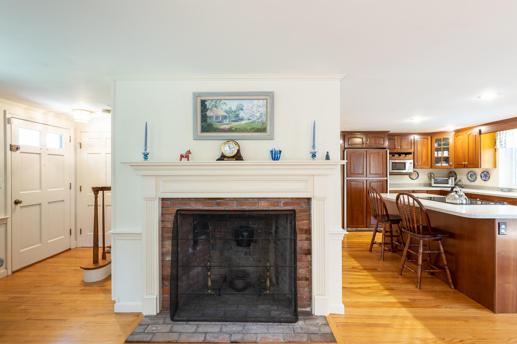 230 Santuit Road Cotuit, MA 02635 - Photo 5 of 46 a living room with furniture a fireplace and a dining table with wooden floor