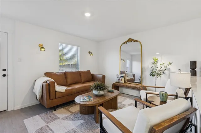a living room with furniture a rug and a window