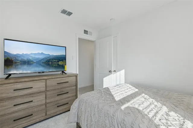 a bedroom with a bed and a television