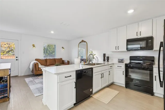 a kitchen with a sink microwave and cabinets
