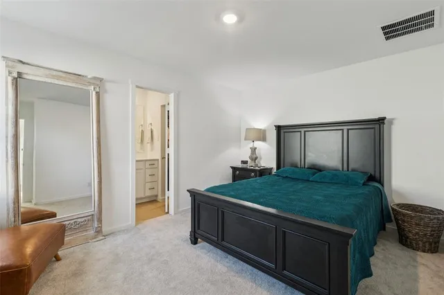 a bed room with a bed and a dresser