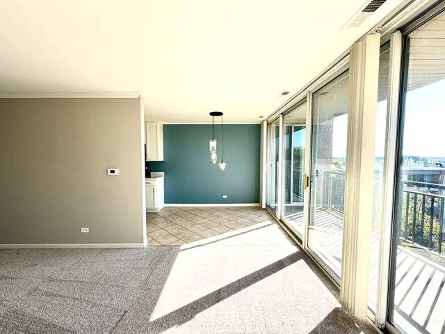 a view of hallway with livingroom and floor to ceiling window