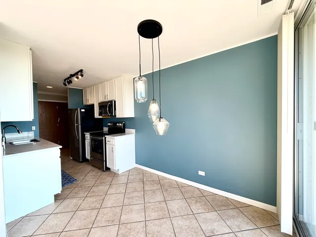 a kitchen with a sink cabinets and appliances