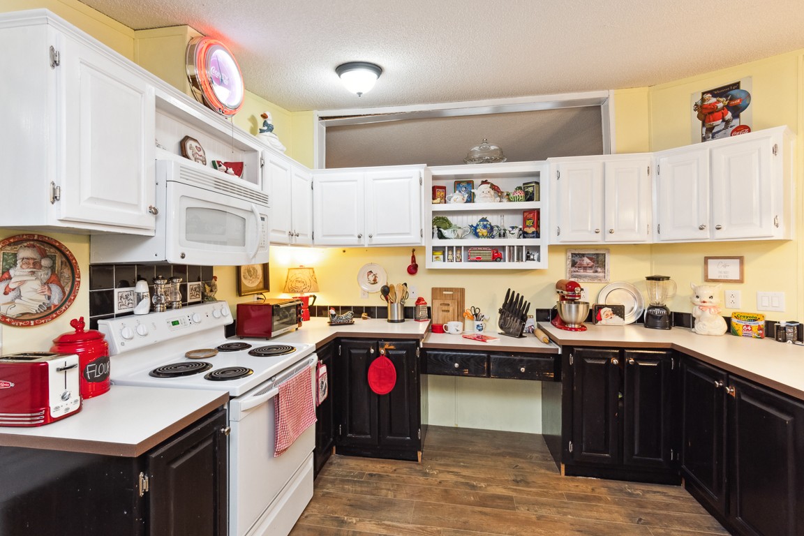 2215 Gwynn Road Lebanon, TN 37090 - Photo 7 of 17 a kitchen with kitchen island granite countertop a sink stove top oven and cabinets