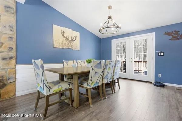 a front view of a house with a yard covered in snow