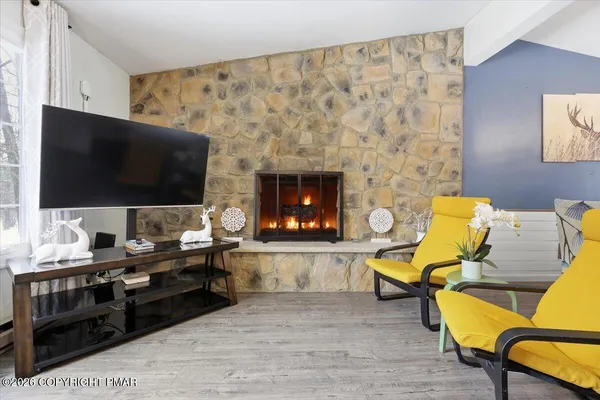 a living room with furniture and a flat screen tv