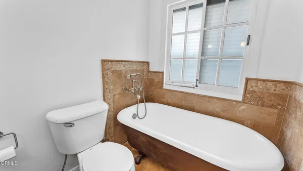 a white toilet sitting next to a bathroom sink