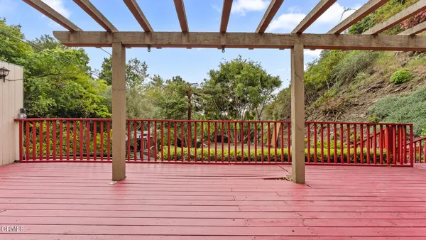 a view of yellow house with wooden fence