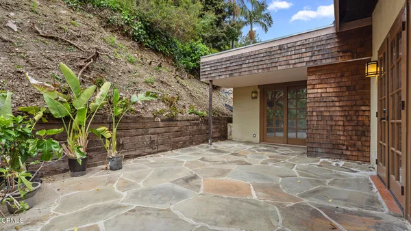a view of empty room with wooden floor and windows