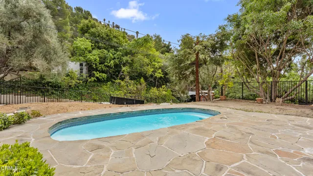 a view of swimming pool with a yard