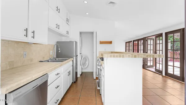 a kitchen with a sink a refrigerator and window