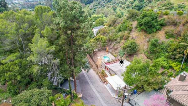 a view of a patio with table and chairs under an umbrella