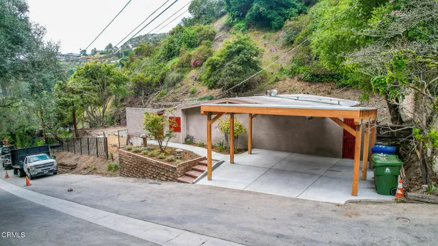 a view of a patio with table and chairs under an umbrella