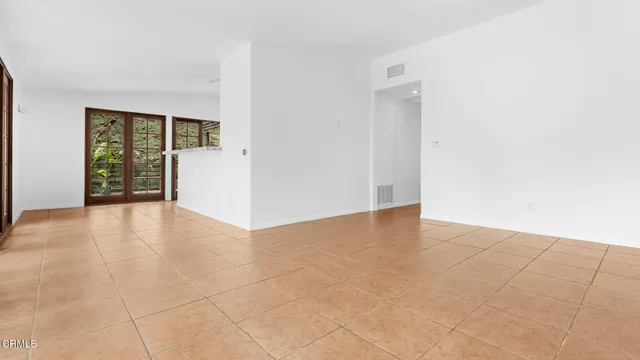 an empty room with windows and entrance