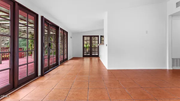 a view of empty room with floor to ceiling window and an entrance