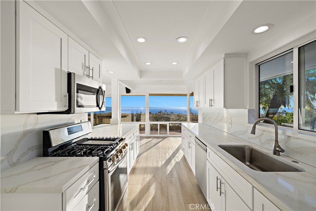 32461 Mediterranean Drive Dana Point, CA 92629 - Photo 11 of 19 a kitchen with stainless steel appliances granite countertop a sink stove and refrigerator