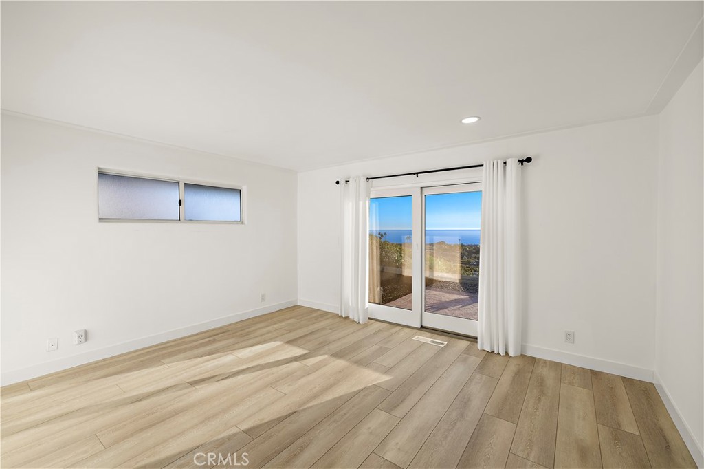 32461 Mediterranean Drive Dana Point, CA 92629 - Photo 12 of 19 a view of an empty room with wooden floor and a window