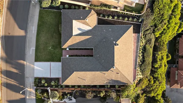 an aerial view of a house with a yard
