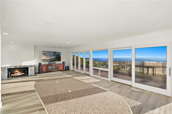 a view of a livingroom with an empty space and a fireplace