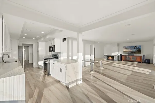 a large white kitchen with cabinets