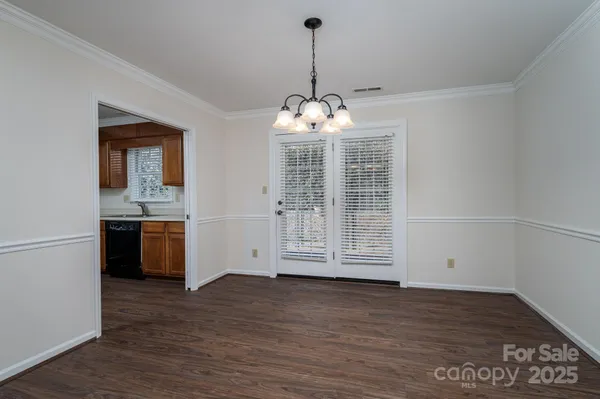 a view of a kitchen with a sink and dishwasher wooden floor