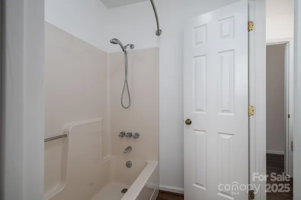 a bathroom with a bathtub and shower