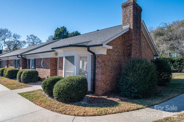 a kitchen with granite countertop a sink cabinets stainless steel appliances and a window