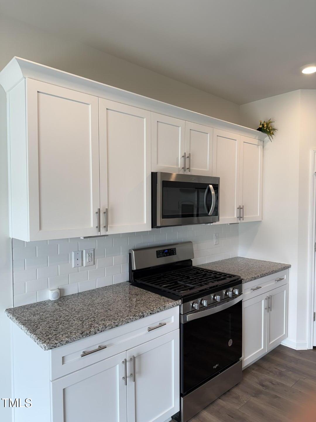2018 Fletchers Ridge Drive Durham, NC 27703 - Photo 12 of 41 a kitchen with granite countertop white cabinets and black appliances