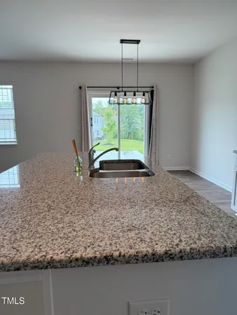 a view of a livingroom with a ceiling fan and entryway