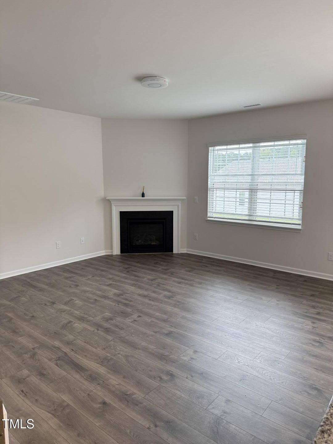 2018 Fletchers Ridge Drive Durham, NC 27703 - Photo 15 of 41 an empty room with a fireplace and window