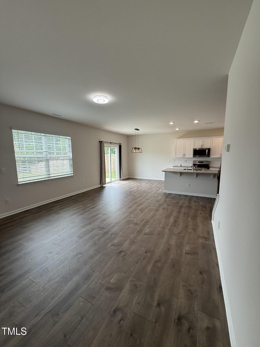 2018 Fletchers Ridge Drive Durham, NC 27703 - Photo 17 of 41 an empty room with wooden floor and windows