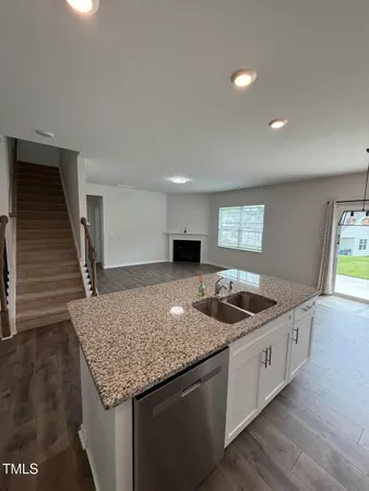 a kitchen that has a sink and a stove